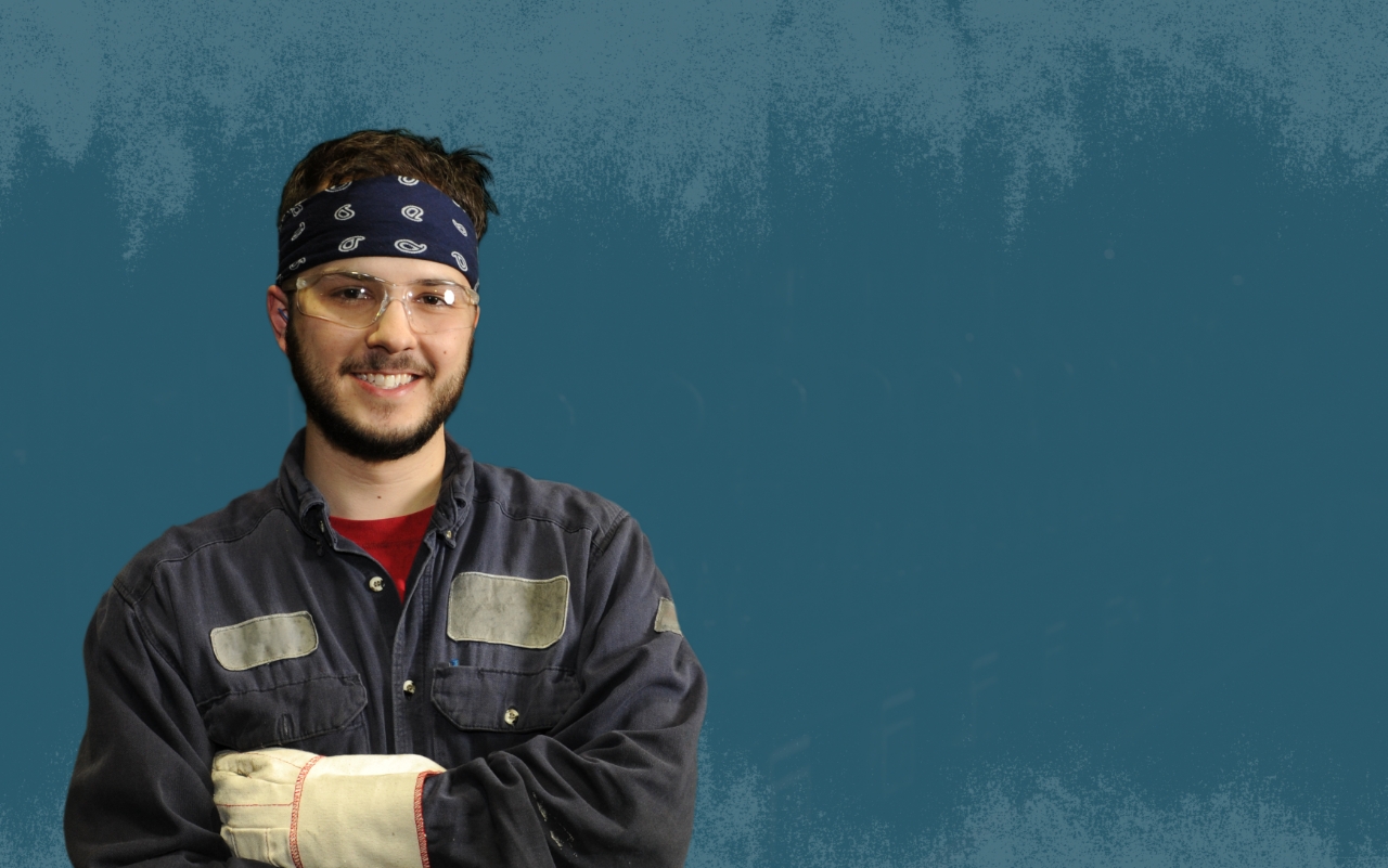 Smiling USW worker in coveralls and bandana